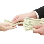 man paying someone with $20 bills